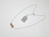 a close up of a necklace with a tag attached to it