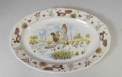 a plate with a picture of a duck and ducklings on it