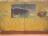 une peinture accrochée au mur d'un immeuble, représentant un homme et une femme