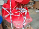 a red chair sitting on top of a pallet in a room