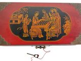 a red and black box with a picture of people playing chess