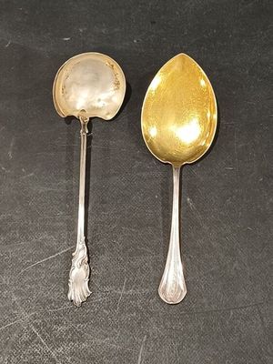 two spoons sitting next to each other on a table