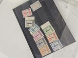 a book with stamps on it sitting on a table next to a pair of scissors