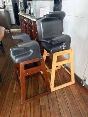 two stools that are sitting on a wooden floor