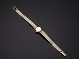 a gold watch on a black background