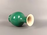 green vase with a gold rim on a white background