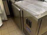 stainless steel counter top in a commercial kitchen with pots and pans on it