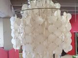 a chandelier made out of plastic bottles hanging from the ceiling