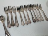 a lot of forks and spoons that are on the table