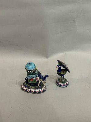 two figurines that are sitting next to each other