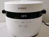 a white bowl with a digital clock on top of it