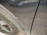 a close up of a car ' s tire on the side of the road
