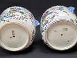 pair of blue and white vases with floral designs on them
