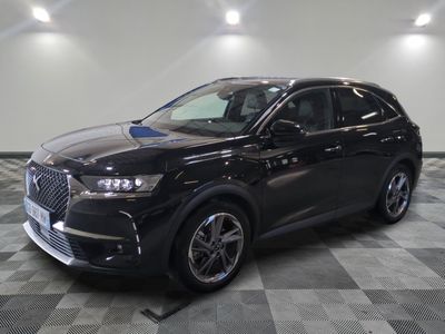the black suv is parked on a checkered floor in a garage