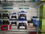 a lot of video game controllers on display in a store