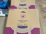 two boxes of cables are sitting on a table next to each other