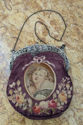 an image of a purse with a picture of a woman on it