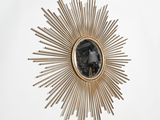 a gold sunburst with a picture of a person in it
