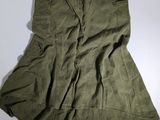 the skirt is green and has buttons on the side