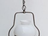 a light hanging from a chain on a wall