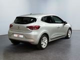 the rear end of a silver car in a white room