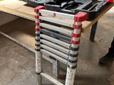 a man that is standing next to a table with tools on it