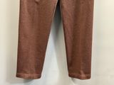 a close up of a pair of brown pants hanging on a wall