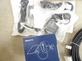 a box of cables and a remote control on a table