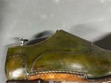 a pair of green shoes that are on a table
