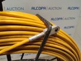a yellow hose with a pair of pliers on top of it