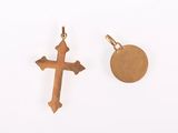 two gold crosses and a gold disc on a white background