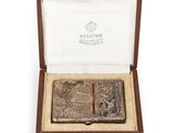 un étui à cigarettes ancien en argent, présenté dans un coffret en bois sur fond blanc