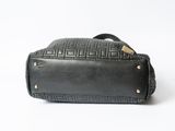 a black handbag with a leather handle on a white background