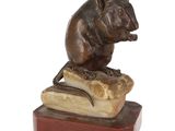 statue of a mouse sitting on top of a piece of marble
