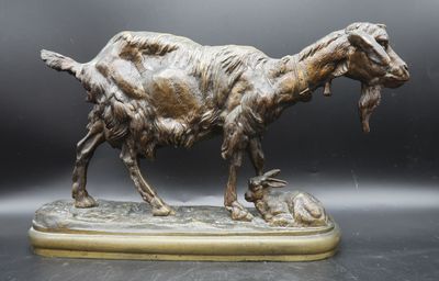 statue of a goat with a fish in it ' s mouth