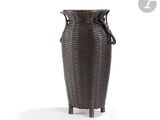 a wicker vase that is sitting on a stand