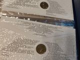 two envelopes that are wrapped in plastic on a table