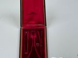 a red box with a pair of scissors in it
