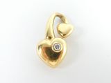 an image of a gold heart charm with a diamond in the middle
