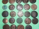 a bunch of coins sitting on top of a green surface