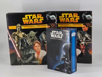two star wars books are sitting next to each other on a white surface