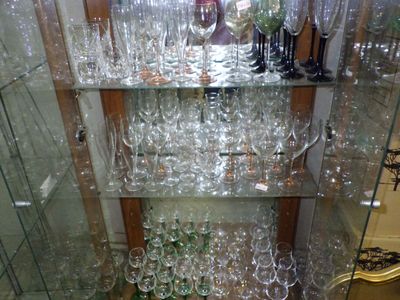many wine glasses on the glass shelves in the room