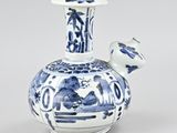a blue and white vase with a bird on it