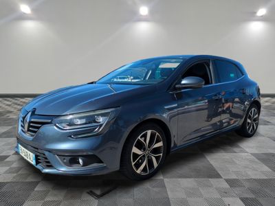 a blue car is parked on a checkered floor in a garage