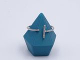 a close up of a ring with a cross on top of it