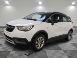 the white opel suv is parked in a large room