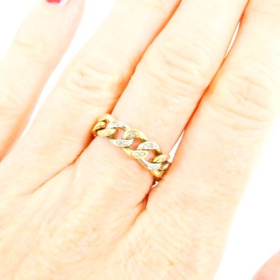 an image of a woman ' s hand with a ring on it