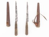 three different types of knives are lined up on a white surface