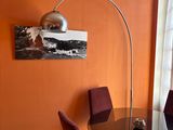 a table and chairs in a room with orange walls