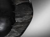 a black and white photo of a sculpture of an apple